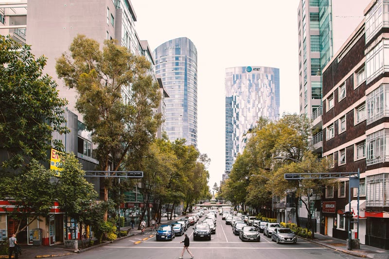 A tree-lined avenue with office towers in Mexico City