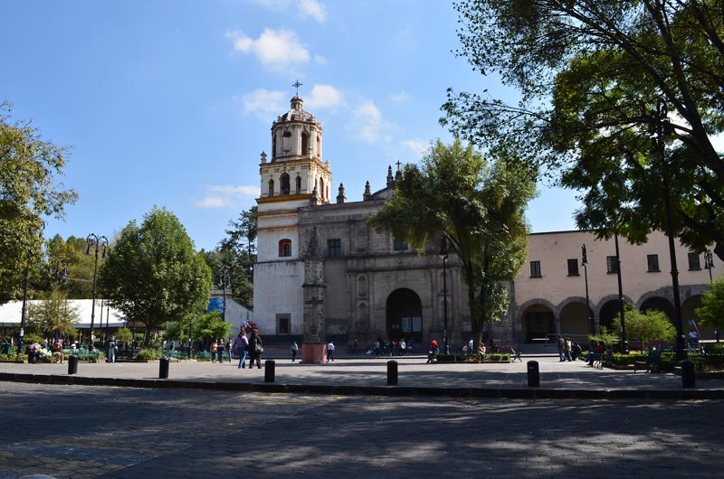A colonial church on a tree-lined plaza in Coyoacán, Mexico City